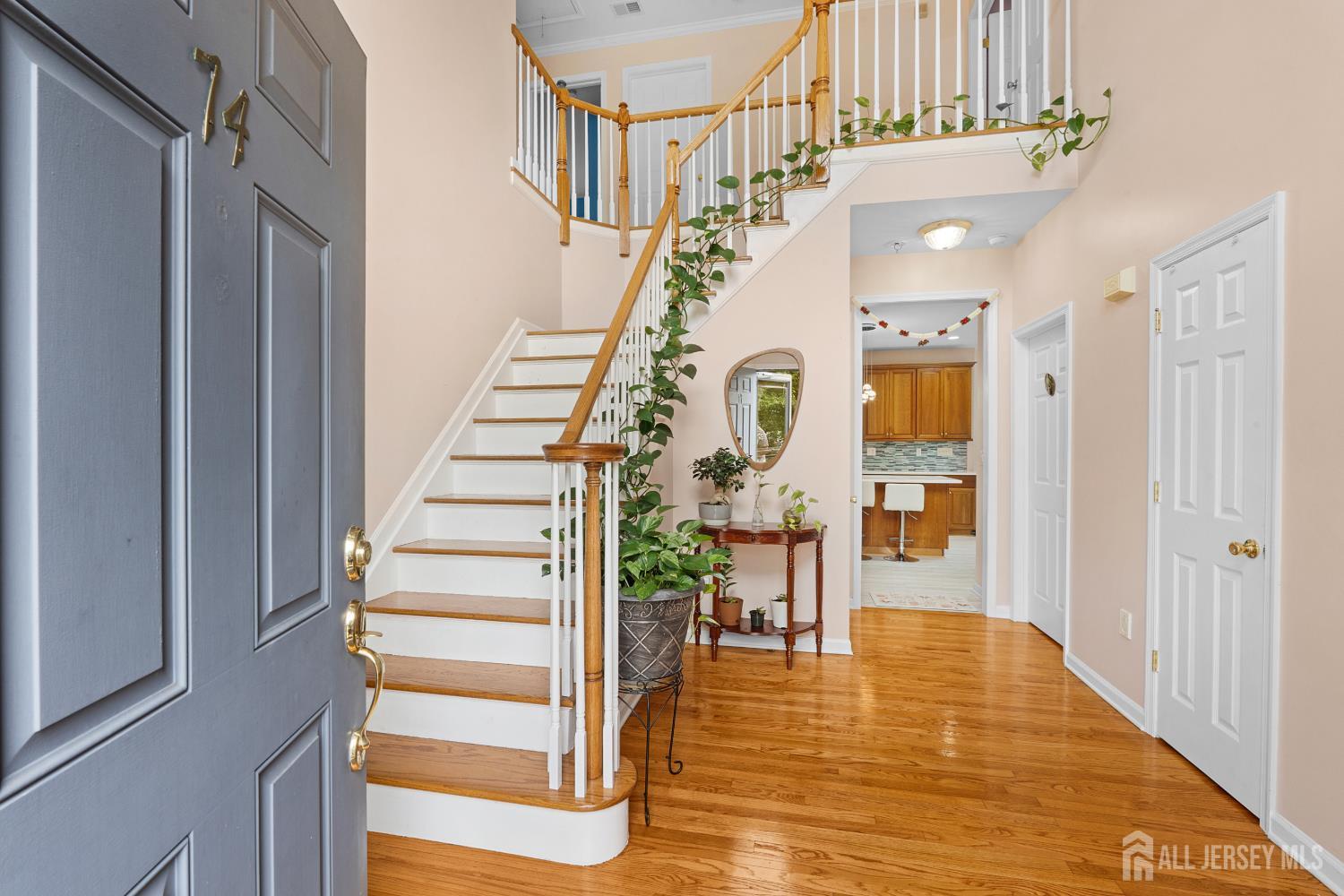 Bright foyer with hardwood floors and staircase at 74 Macfarlane Circle